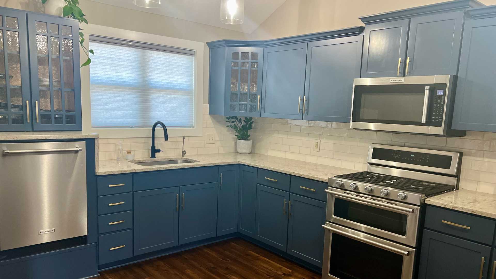 modern farmhouse kitchen with blue cabinets and white subway backsplash tile